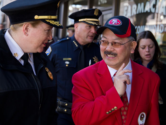 Fire Chief Joanne Hayes White walks with Mayor Ed Lee as they visit merchants in the Mission District neighborhood to highlight the cities efforts to respond to the outcome of the 49ers game on Sunday. (Deborah Svoboda/KQED)