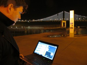 Artist Leo Villareal controls the Bay Lights with his laptop. (Cy Musiker/KQED)