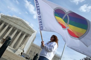 Same-sex marriage proponent Kat McGuckin of Oaklyn, New Jersey, holds a gay marriage pride flag while standing in front of the Supreme Court November 30, 2012 in Washington, D.C. (Chip Somodevilla/Getty Images)