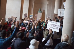 Hundreds of protesters marched into City Hall asking for the mayor to commit to further funding the school. (Deborah Svoboda/KQED)