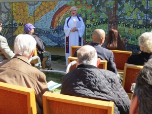 Rev. Kathryn Pike dedicates the new mosaic mural at Bethany Presbyterian Church. Three of the eight people who died in the fire were members of the church. (Francesca Segre/KQED)
