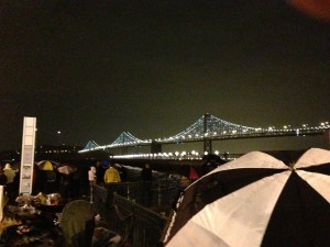 Umbrellas sprouted before the lights came on. (Cy Musiker/KQED)