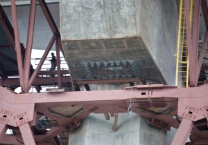 A view of the underside of the eastern side of the new Bay Bridge on March 27. Bolts can be seen in a rectangular formation in the center of the photo. Thirty-two steel rods on the new eastern span have snapped. (Deborah Svoboda/KQED)