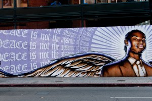 "Peace is not the absense of tension," mural in downtown Oakland. Muralists throughout Oakland have tackled police brutality and local violence. (Keoki Seu/Flickr)