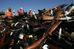  Steel workers look over a pile of more than 4,300 confiscated illegal weapons about to be melted down during the 14th Annual Gun Destruction program. (David McNew/Getty Images)