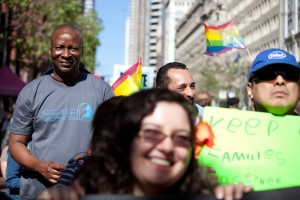 Adoubou Traore (left) marches with about 1,000 people in San Francisco on a national day of action, to support a comprehensive immigration reform that includes a path to citizenship. (Deborah Svoboda/KQED)