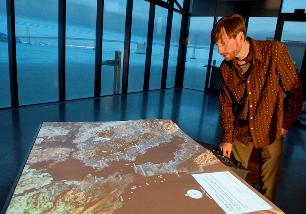 Exploratorium scientific content developer Sebastian Martin and an interactive map of the Bay Area in the Bay Observatory. 