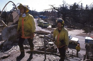 Firefighters overlook the damaged structures after the Oakland Hills fire burned dozens of neighborhoods and thousands of homes. (Credit: CalEMA)