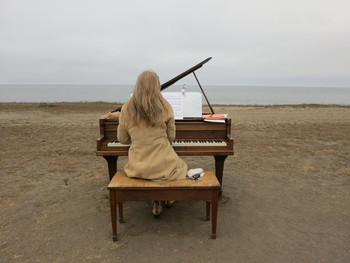 The dozen old pianos that Artist Mauro Fortissimo hauled out to the beaches of San Mateo County are inspiring spontaneous concerts. (Francesca Segrè/KQED)