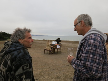 Neighbors and tourists gather around the old pianos that Artist Mauro Fortissimo hauled out to the beaches of San Mateo County. (Francesca Segrѐ/ KQED)