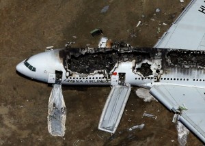 A Boeing 777 airplane lies burned on the runway after it landed at San Francisco International Airport July 6, 2013. (Ezra Shaw/Getty Images)
