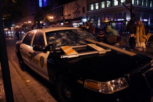It took about 20 seconds for a handful of people to destroy this empty BART Police car parked near 12th and Broadway during a July 13, 2013, march in Oakland protesting the acquittal of George Zimmerman for killing unarmed black teenager Trayvon Martin last year in Florida. (Alex Emslie/KQED)