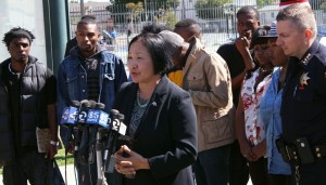 Oakland Mayor Jean Quan, with interim Police Chief Sean Whent and representatives from Youth Uprising, discuss the city's violent crime strategy on Wed, Aug. 8. (Alex Emslie/KQED)