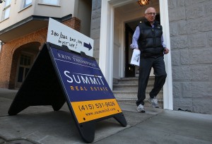 A sign is posted in front of a home for sale during an open house. Increasing inventory could slowdown rising asking prices. (Justin Sullivan/Getty Images)