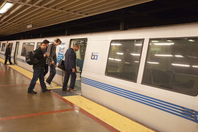 On the first night of the Bay Bridge closure, BART runs trains all night. About a dozen people wait in MacArthur BART station to take the 1:28 am train to San Francisco. Photo by (Deborah Svoboda / KQED)
