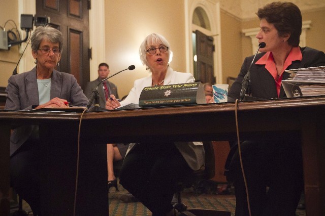 California Senator Hannah-Beth Jackson (left) and California State Auditor Elaine Howle (right ) listen as California Assemblymember Bonnie Lowenthal asks the state’s legislative audit committee to look into the practice of sterilization of female inmates. (Randy Allen / The Center for Investigative Reporting)