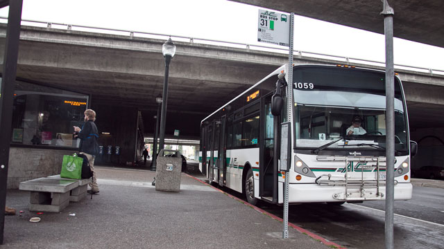 An AC Transit bus waits at Macarthur BART station in Oakland. (Deborah Svoboda/KQED)