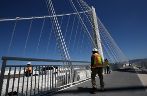 A worker walks on the bike path next to the new Bay Bridge self-anchored suspension tower. After nearly 12 years of construction and an estimated price tag of $6.4 billion, the new eastern span of the Bay Bridge will open tonight. The new self-anchored suspension tower is the world's largest. (Justin Sullivan/Getty Images)