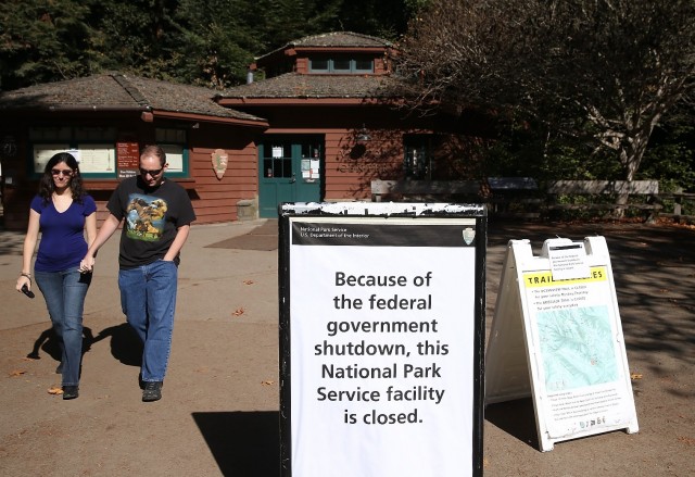 A couple leaves Muir Woods in Marin County, one of many National Park Service sites in the Bay Area closed during this month's federal government shutdown. (Justin Sullivan/Getty Images)