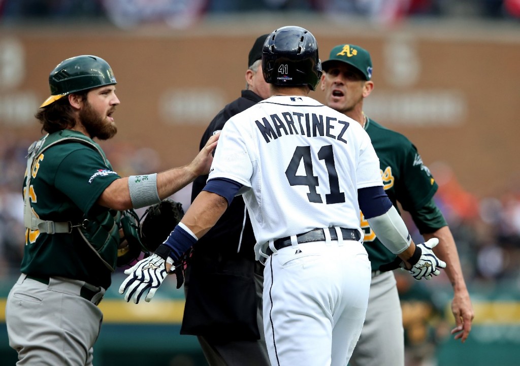 Oakland A's catcher Derek Norris, left, tries to calm Victor Martinez of the Detroit Tigers, who took exception to comments from A's pitcher Grant Balfour, right. (Leon Halip/Getty Images)