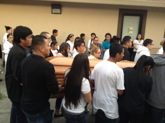 Pallbearers, including many classmates of Andy Lopez, carry his casket into the church. (Rachel Dornhelm/KQED)