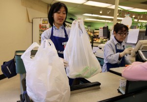 A cashier bags groceries in plastic bags at Nijiya Market June 2, 2010 in San Francisco, California. (Photo by Justin Sullivan/Getty Images)