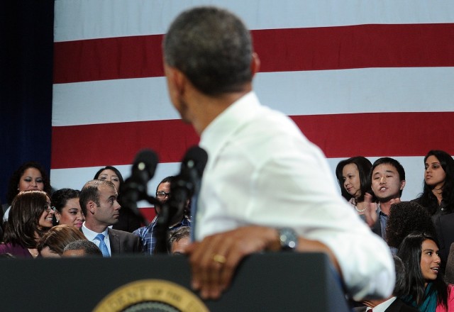 A man (in background, second from right) heckles President Obama as he addressed an audience at San Francisco's Betty Ann Ong Chinese Recreation Center on the topic of immigration reform. (Jewel Samad/Getty Images)