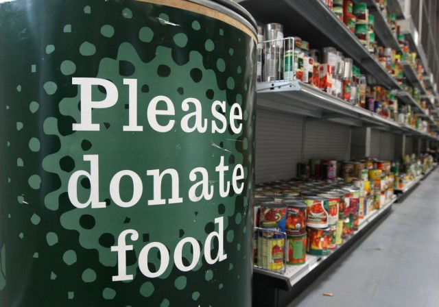 A donation bin sits near shelves with canned foods at the San Francisco Food Bank in 2008. (Justin Sullivan/Getty Images)