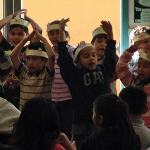 First grade Mission Education Center students sang "I Am A Turkey" as part of the Thanksgiving festivities. (Katrina Schwartz/KQED)