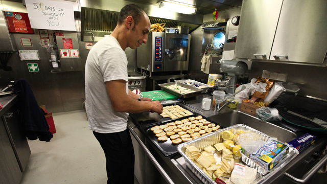Sophiane Benaouda, a local caterer, prepares dinner in the ships galley for a big event they are hosting that night. The Rainbow Warrior caters to an international crew by offering carnivorous, vegetarian and vegan dish for almost every meal served. (Deborah Svoboda/KQED)