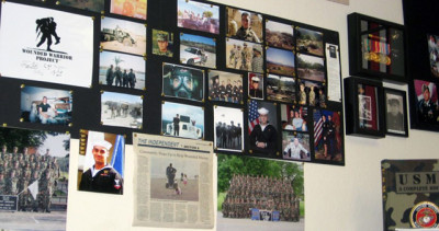  In the reception room of Valor Winery, there's a wall where vets and their families post photos. ( Aarti Shahani/KQED)