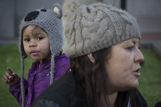 Nyla Bonner, 2, enjoys a free meal with her mother Chelan Cassidy at U.N. Plaza in San Francisco. (Sara Bloomberg/KQED)