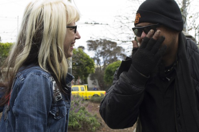 Mary Howe talks to Ulysses, a homeless man who has used the services at the Homeless Youth Alliance, near Stanyan and Haight streets. (Sara Bloomgberg/KQED)