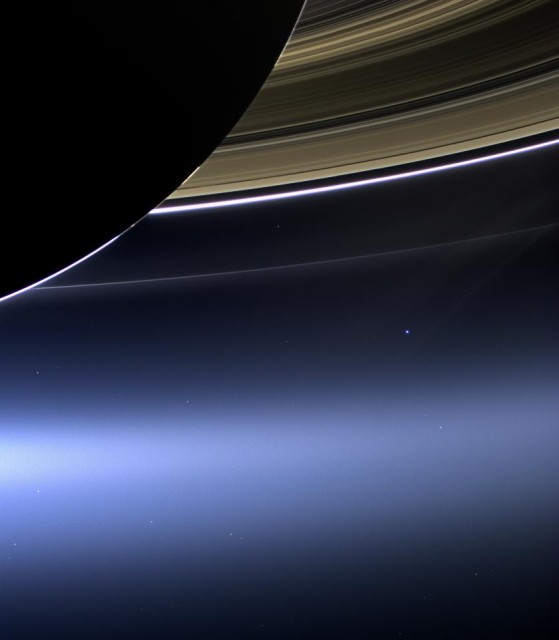 A view of Saturn and its rings with a distant Earth--the bright blue dot at lower right--in the background. (NASA/ESA)