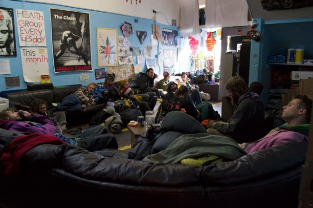 Homeless youth rest and watch television at the Homeless Youth Alliance on Dec. 18, 2013, seven days before the organization has to close its doors to prepare to move everything into storage. (Sara Bloomberg/KQED)