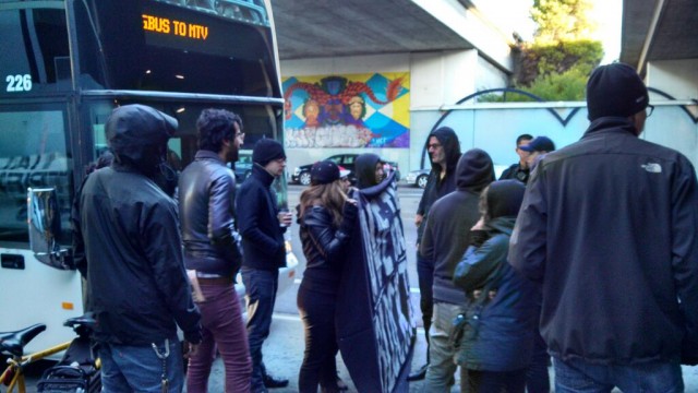 A Google bus halted by protesters Friday morning at Oakland's MacArthur BART station. (Grace Rubenstein/KQED)