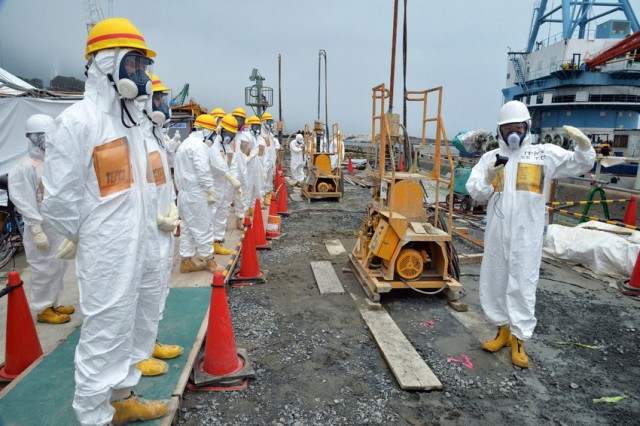 Japanese government officials and nuclear experts inspect work at the badly damaged Fukushima nuclear plant.  (AFP-Getty Images)