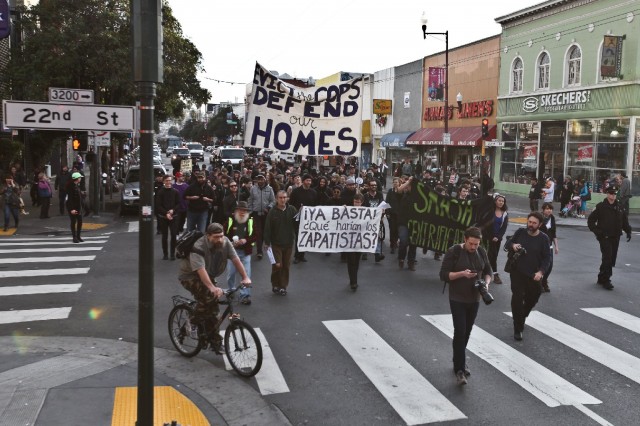 About 100 protesters and residents welcomed the new year by marching from the 24th Street BART to the 16th Street BART station on New Year's day. They were protesting the police enforcement of evictions and claim the Mission is being turned into "a playground for the rich."   (Deborah Svoboda/KQED)