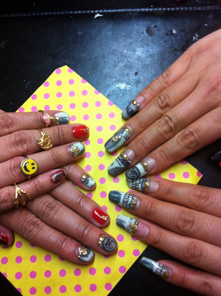 Nail artist Britney Tokyo gives friend and client Roxy Ferrari a manicure using a few Cha Cha Cover decals, paint and charms. (Caitlin Esch/KQED)