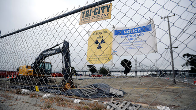 Radioactive warning signs are posted on the fence surrounding a cleanup site on Treasure Island in 2012. (Michael Short/The Center for Investigative Reporting)