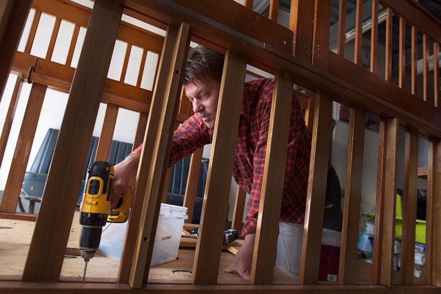 Kloehn works on his newest tiny house, which is made mostly from old beds. (Mark Andrew Boyer/KQED)