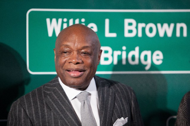 Former San Francisco Mayor and California Assembly Speaker Willie Brown poses with the sign now bearing his name. (Mark Andrew Boyer / KQED)