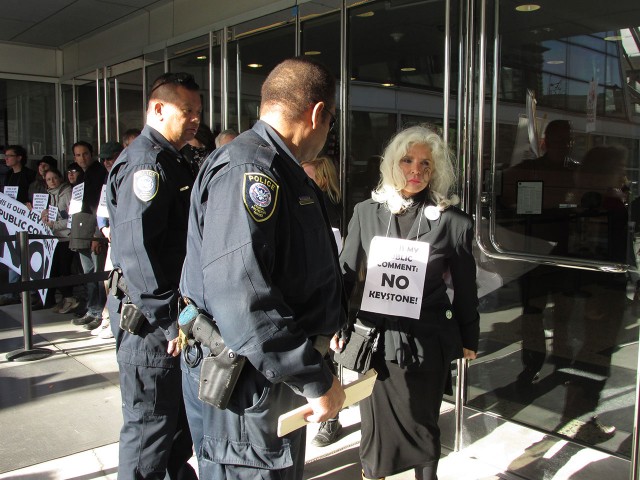 An activist blockading the Federal Building is detained by Police. (Jack Detsch/KQED) 