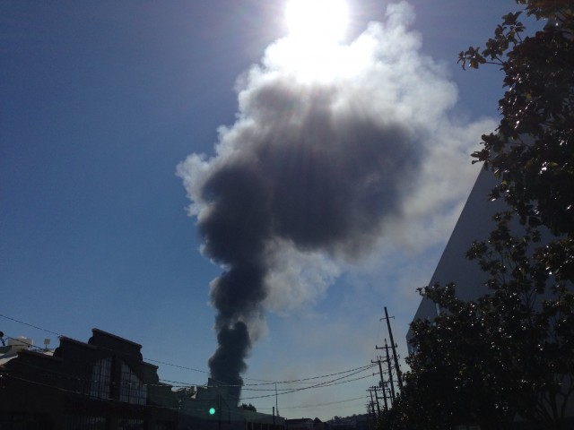 Smoke plume rises from three-alarm fire Monday in San Francisco's Bayview District. (Paul Lancour/KQED). 