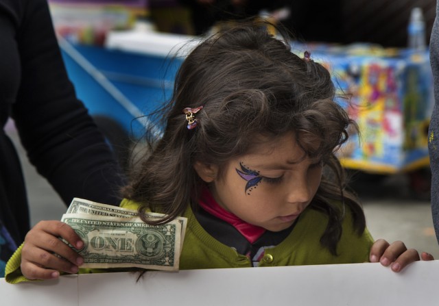 A child buys tickets at the Halloween-Día de los Muertos fundraiser for Junipero Serra Elementary in Bernal Heights. The event netted $3,000 for the PTA. (Tearsa Joy Hammock / San Francisco Public Press)