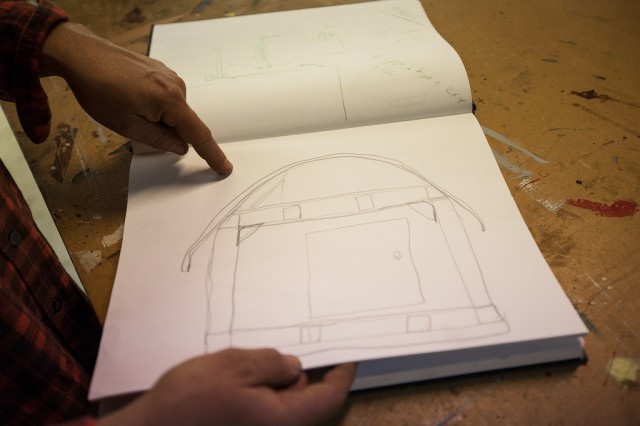 Kloehn shows off sketches of some of his previous tiny homes. (Mark Andrew Boyer/KQED)