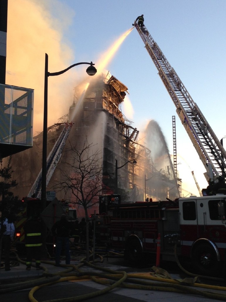 Firefighters pour water over a five-alarm fire in China Basin. (Charla Bear/KQED)