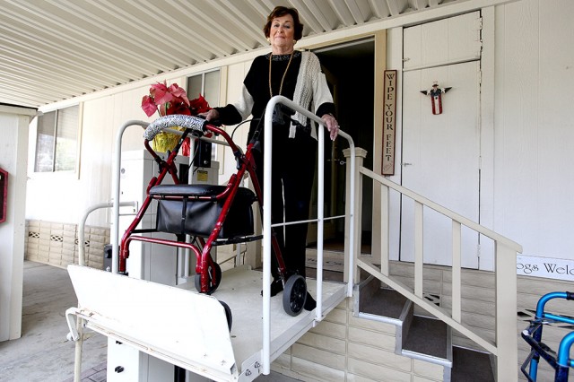 Barbara Cali, co-founder and resident of Winchester Ranch, stands on the lift at the entrance of her home. (Mark Andrew Boyer/KQED)
