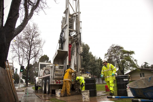 An environmental remediation crew digs a groundwater monitoring well on the property of First Presbyterian Church in Newark. (Mark Andrew Boyer/KQED)
