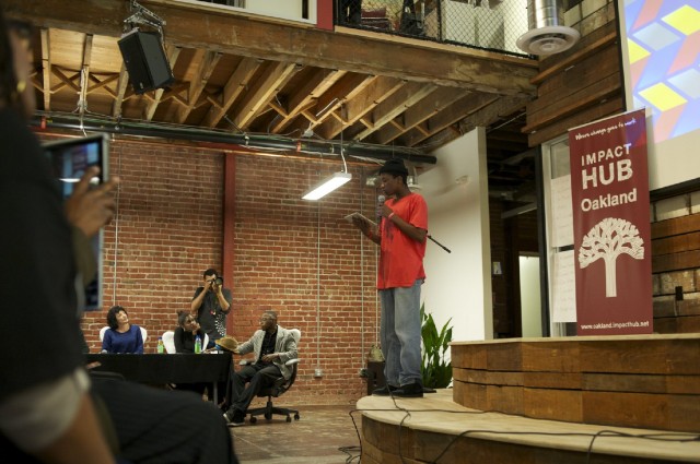 Johnnel White pitches his app to a panel of judges and community audience. (Monica Lam/KQED)